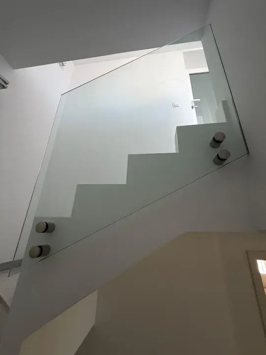 Toughened glass staircase balustrade with stainless steel fixings