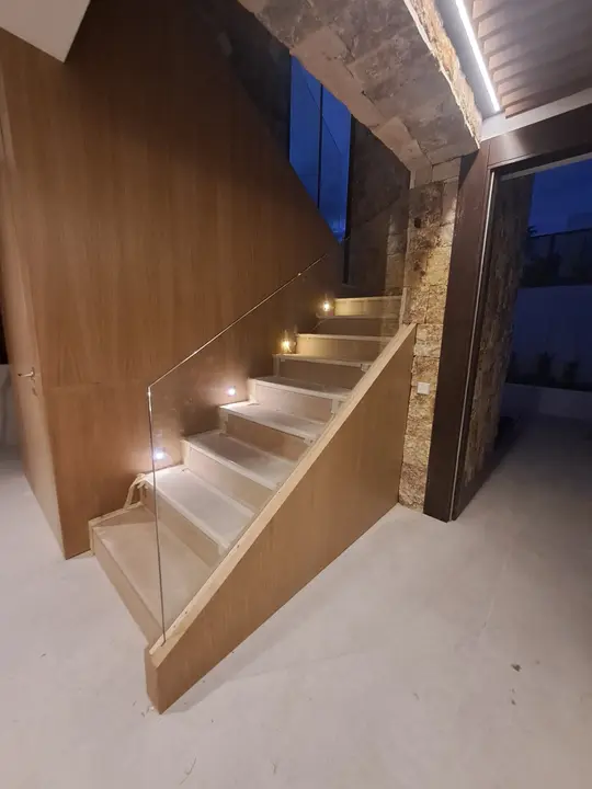 Glass balustrade on a wood-clad staircase