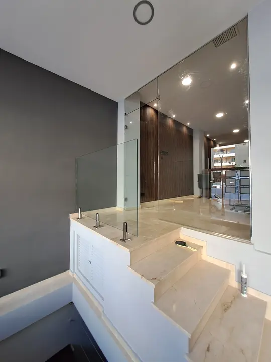 Glass balustrade on a marble indoor staircase