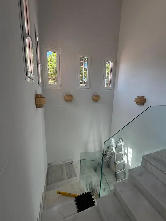 Glass balustrade in a stairwell with stained-glass windows