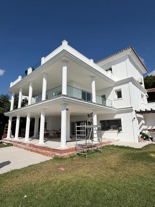 Glass balustrade on a white villa terrace