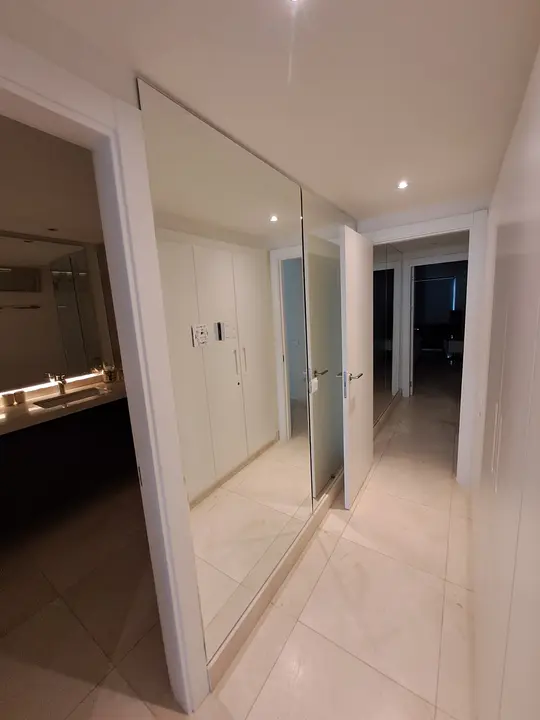 Floor-to-ceiling wall mirror in a hallway