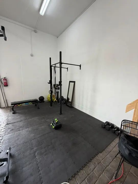 Mirror installation in a gym with a training rack