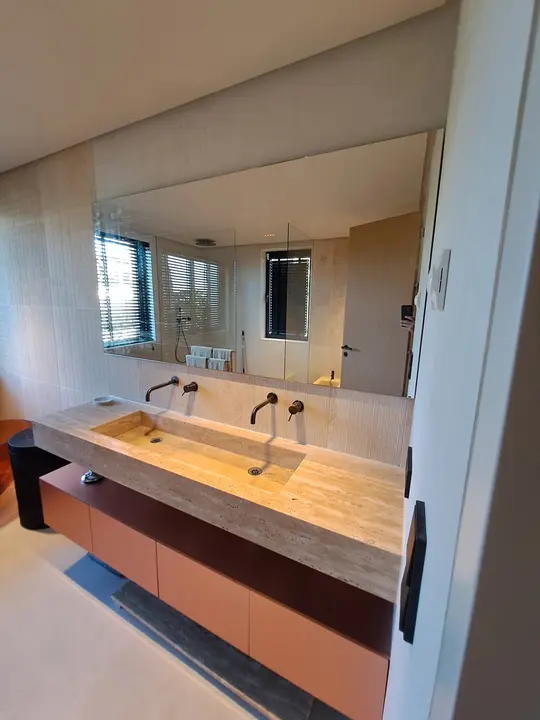 Large mirror in a bathroom with a double basin