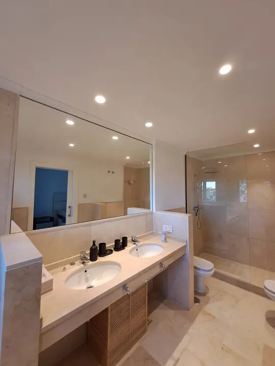 Large mirror above a double washbasin