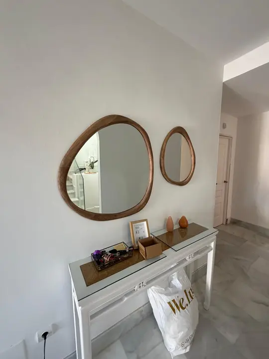 Oval wooden-framed mirror in an entrance hall