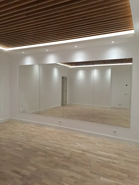 Wall mirror in a room with a wooden ceiling