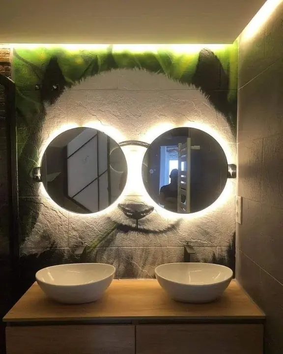Round mirrors with integrated LEDs in a decorative mural