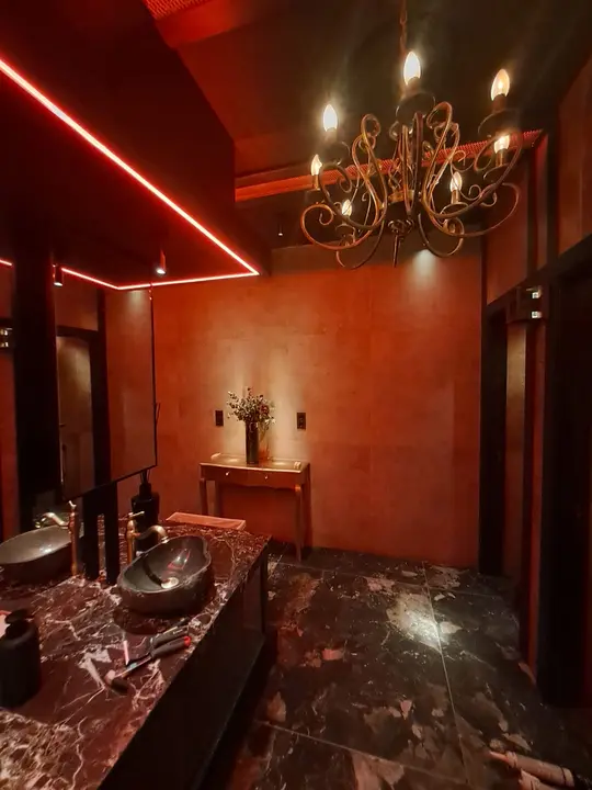 Hospitality cloakroom with a mirror and chandelier