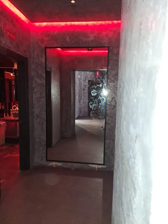 Floor-to-ceiling mirror in a hallway with LEDs