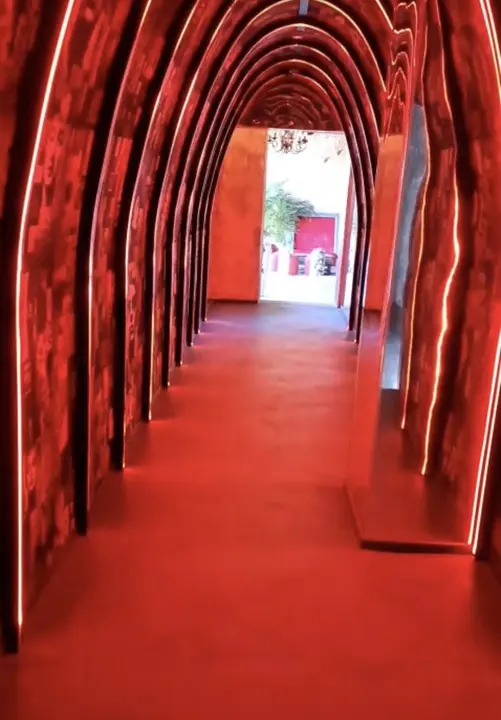 Entrance tunnel with illuminated arches and mirrors