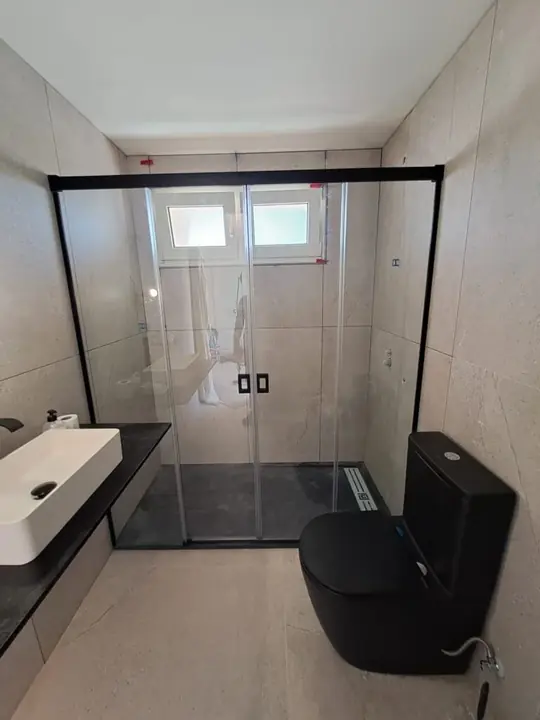 Shower screen with a black profile and a window
