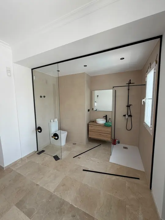 Shower screen with a black profile in an en-suite bathroom