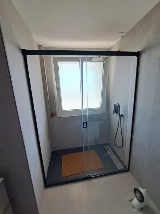 Shower screen with a matt black profile