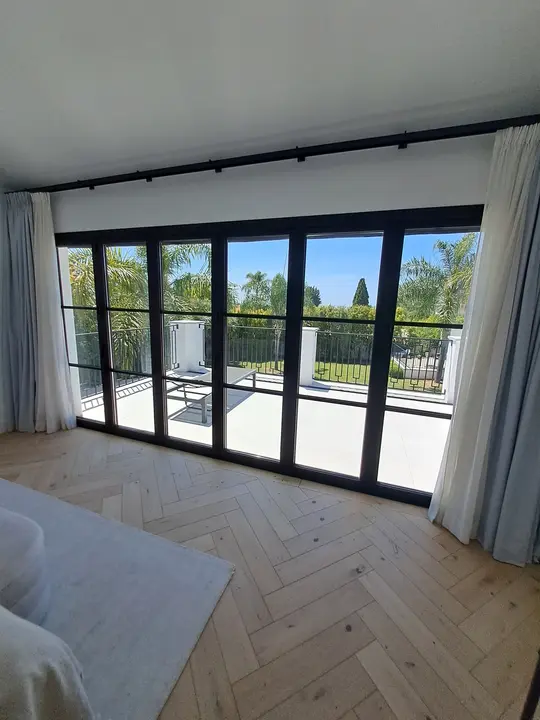 Glass windows with black profiles in a bedroom